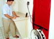 Photo of man monitoring blower door test.