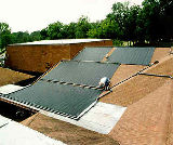 Picture of a uniquely mounted solar hot water system on a pool in North Florida.
