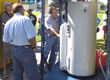 Picture of a people inspecting a water tank.