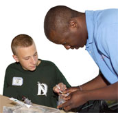 Photo of teacher helping student.