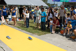 Photograph of students racing model solar cars.