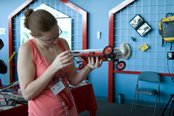 Photograph of Krissy Schroen holding a JSS model car.