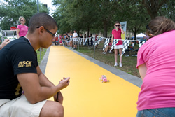 Photograph of official timing the pink Race Girls model fuel-cell car.