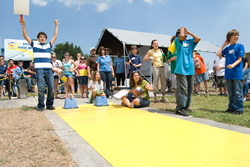 Photograph of students racing model solar cars.