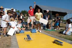 Photograph of students racing model solar cars.