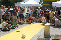 Photograph of students racing model solar cars.