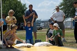 Photograph of students racing model solar cars.