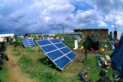 photo of photovoltaic arrays set up on grass in disaster area