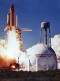 photo of Space Shuttle Challenger lifting of next to hydrogen storage tank