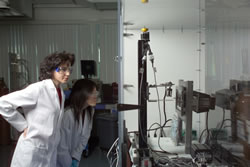 Photo of two researchers using the catalyst sprayer.